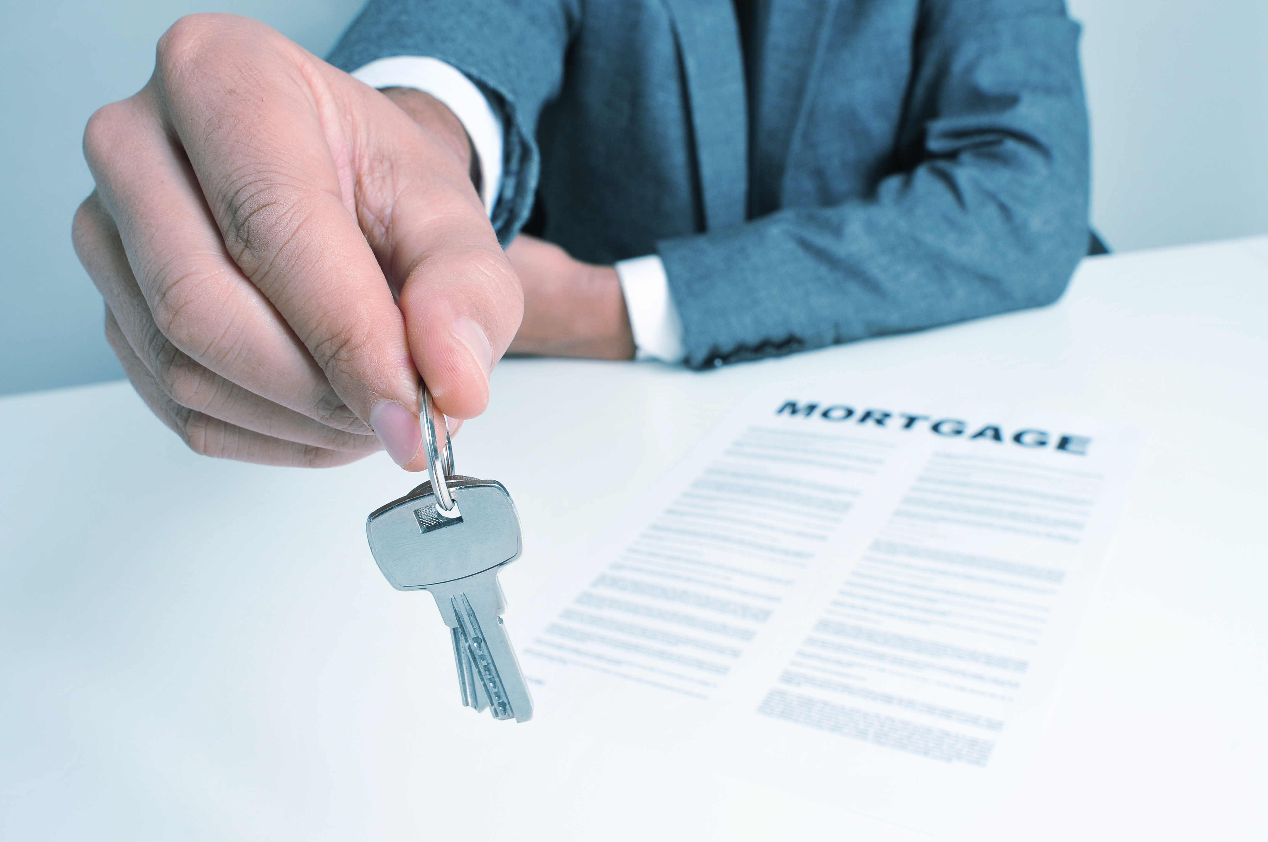 Man handing key ring to person