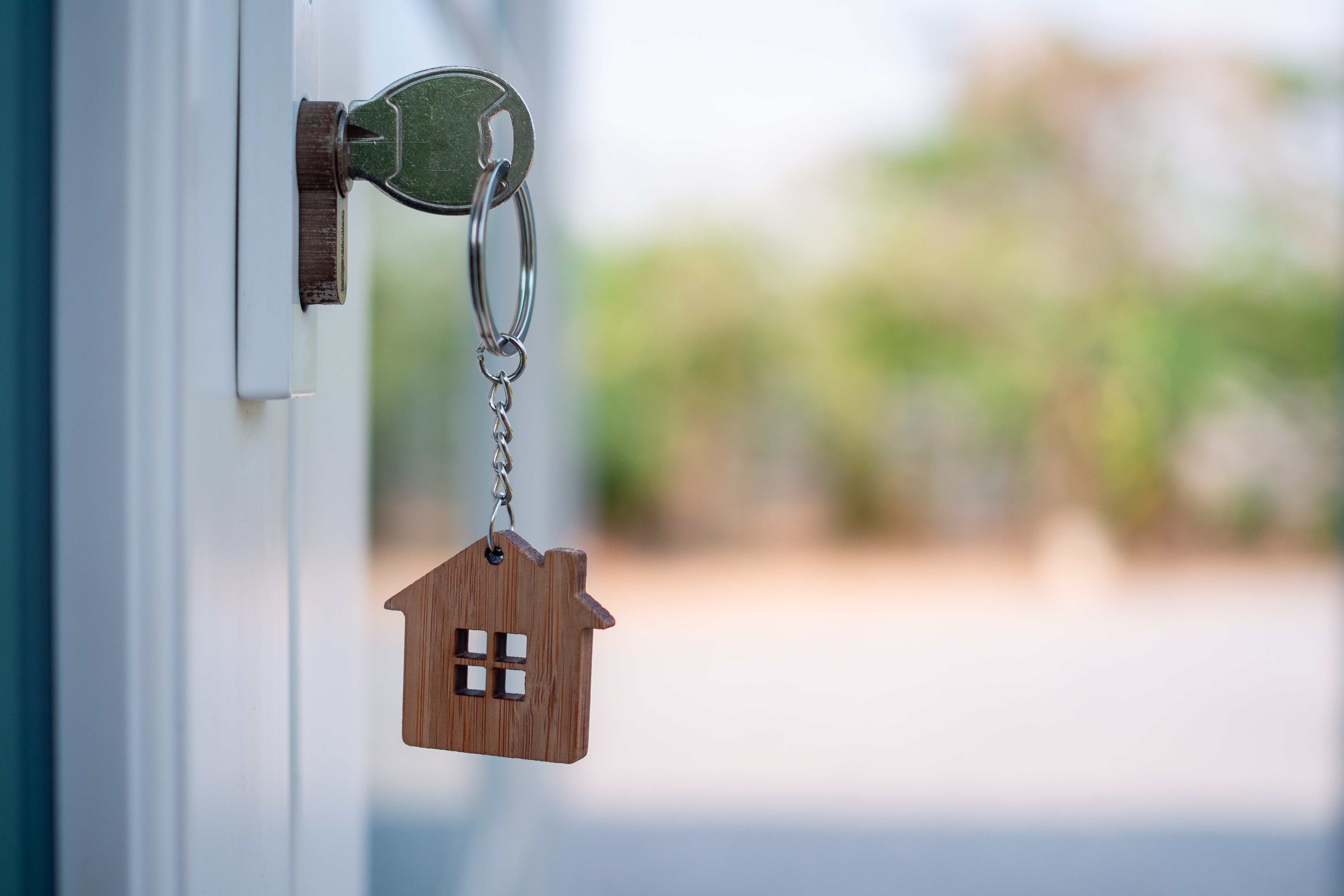 Key in door with a house keychain