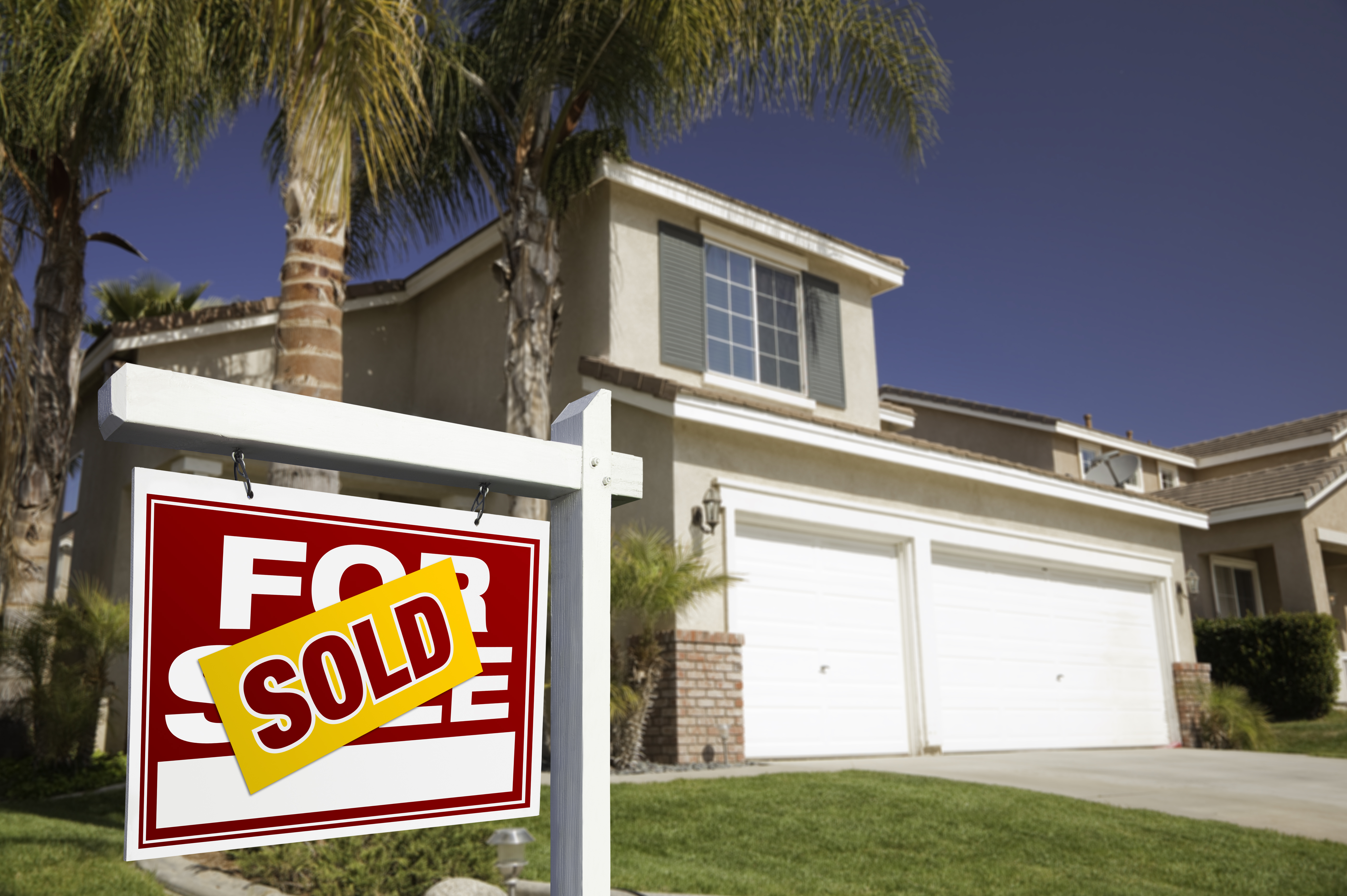 House with a for sale sign with sold over top