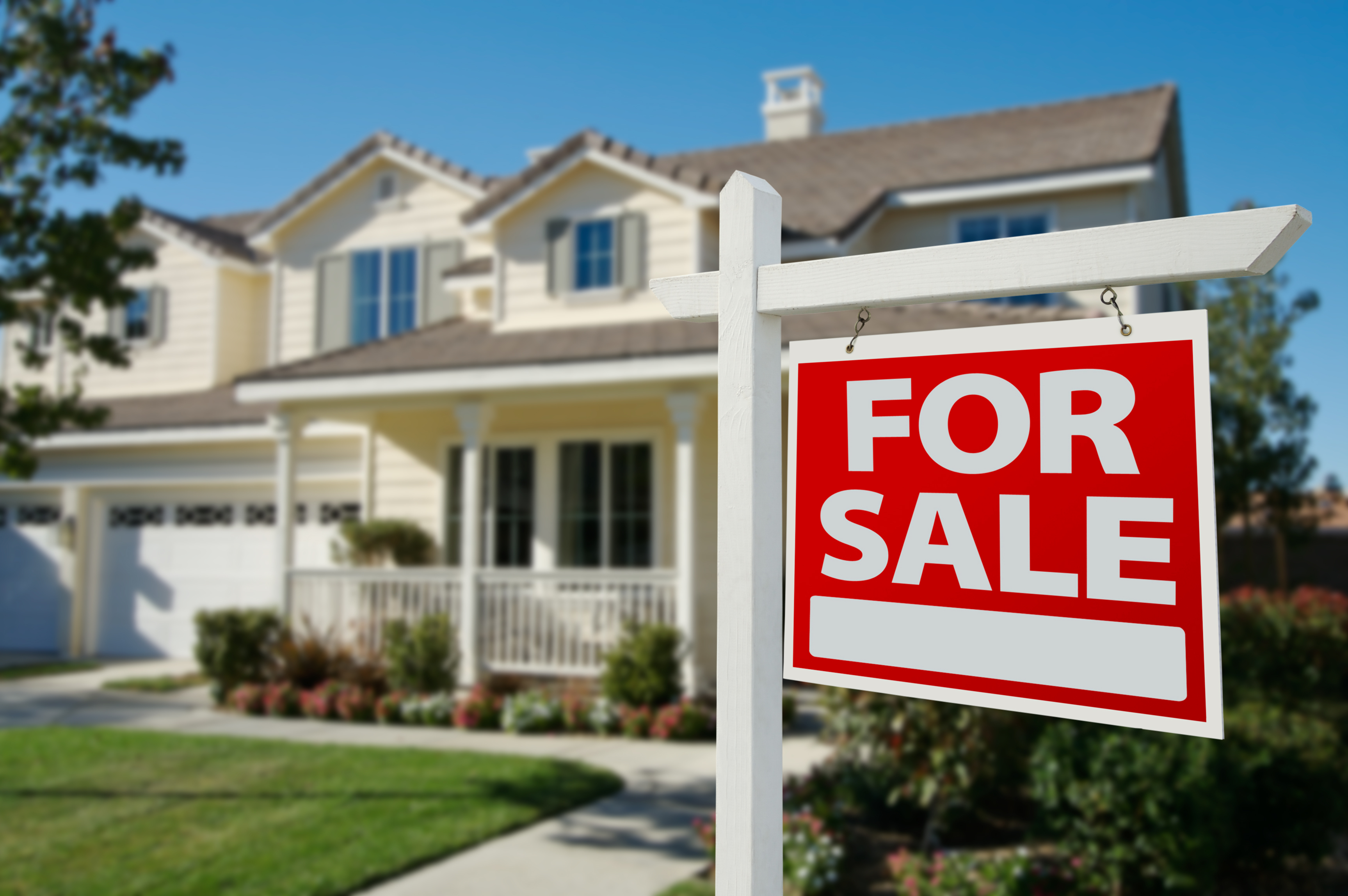 House with a for sale sign in front