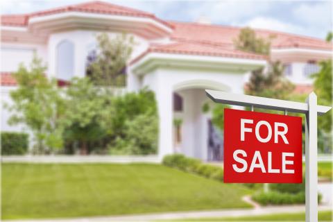 House with a for sale sign in front