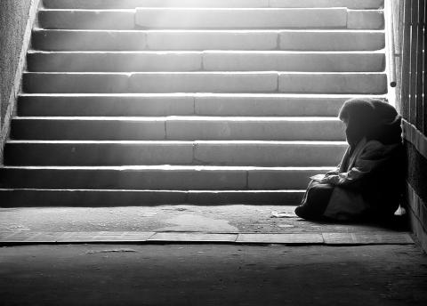 Woman sitting at the bottom of steps